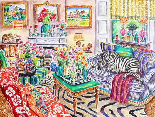 A young Zebra lies on a blue and white striped sofa.  A zebra rug is on the floor.  This is a maximalist designed room.  There are several vases of colorful flowers throughout the room.  There are statues of animals throughout the room including a giraffe, a fox, an elephant, a horse and a dog.  Two paintings by Gaughan hang on the wall on either side of the fireplace and are framed in gold frames.  Colorful pillows are on the sofa and there is a red and white tropical patterned chair as well as a green and