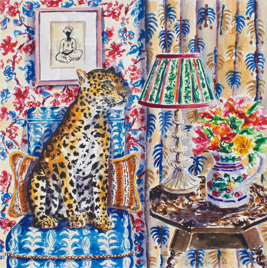A colorful watercolor-style illustration of a leopard sitting on a blue patterned armchair in a , maximalist style decorated room with floral wallpaper, a lamp, flowers, and framed art.