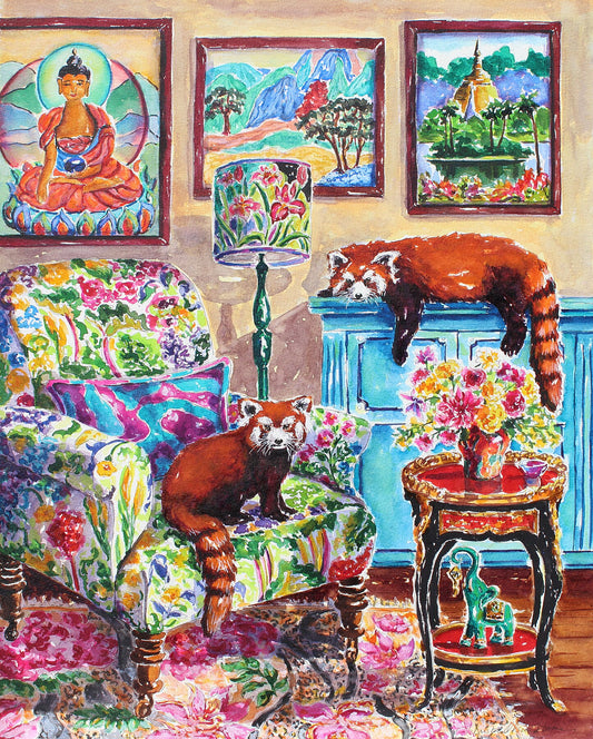 A pair of red pandas are in a cozy sitting room.  One is lying on the buffet and the other is sitting in a chair with a floral print.  A Good Luck Elephant is on the bottom shelf of an ornate asian style coffee table.  A painting of The Buddha is on the wall as well as a South East Asian temple landscape.  Wall decor for art collectors