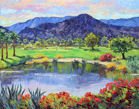 An oil painting of an Indian Wells desert landscape featuring palm trees and mountains, with a pond and a golf course in the foreground.